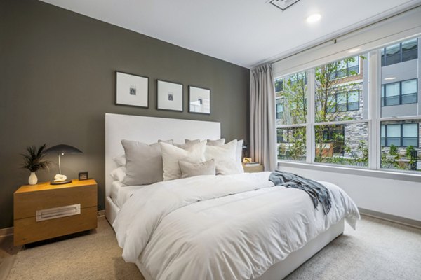 Bedroom with modern decor and natural light at Enclave at Raritan Apartments â€“ luxury living by Greystar