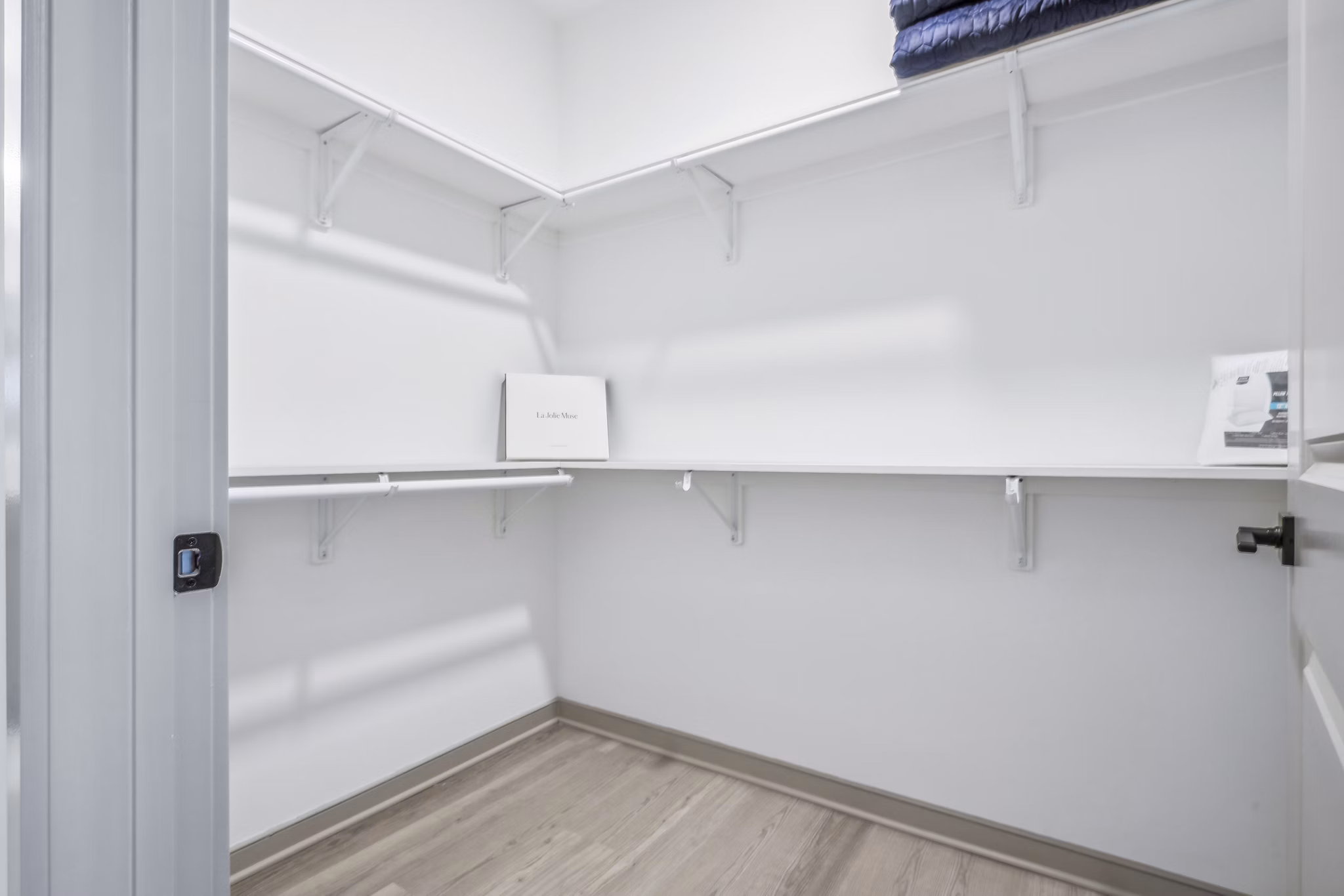 Bedroom closet featuring custom shelving and ample storage at Enclave at Raritan Apartments