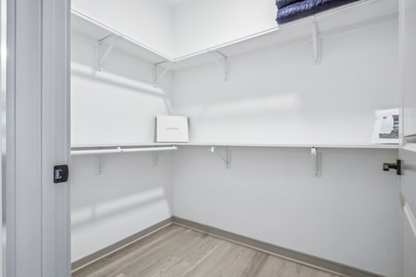 Bedroom closet featuring custom shelving and ample storage at Enclave at Raritan Apartments