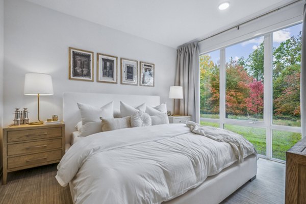 Cozy bedroom with modern furniture and natural light at Enclave at Raritan Apartments