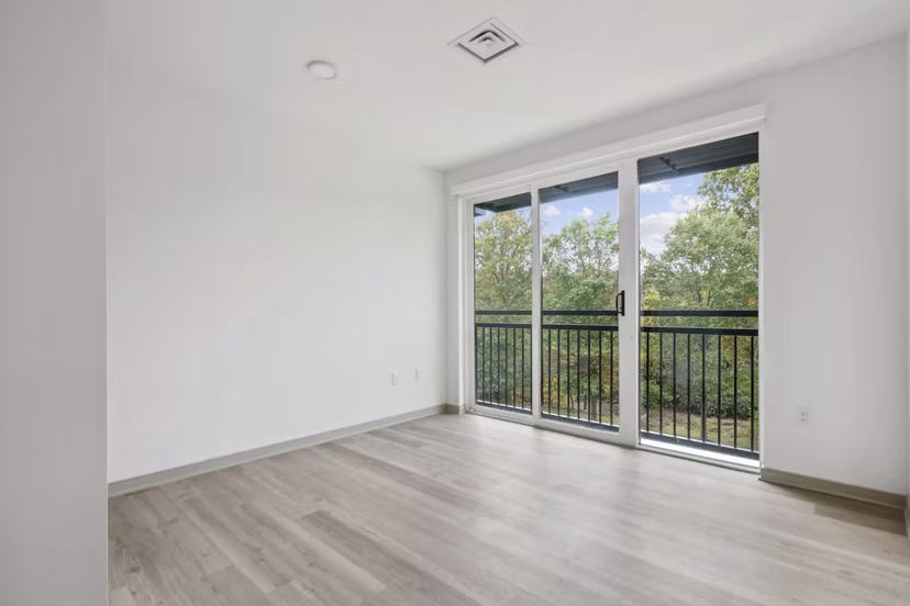 Spacious living room with hardwood floors and modern decor in Enclave at Raritan Apartments