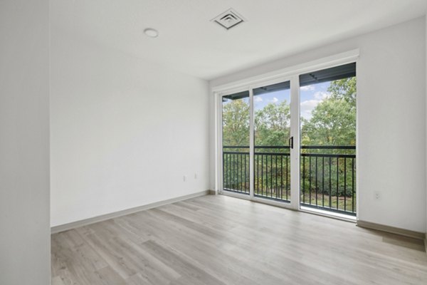 Spacious living room with hardwood floors and modern decor in Enclave at Raritan Apartments