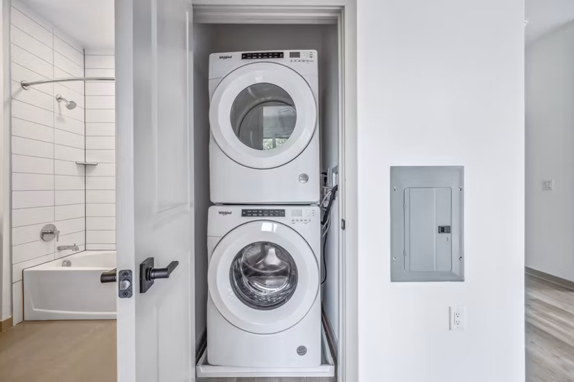 Laundry room with modern appliances at Enclave at Raritan Apartments