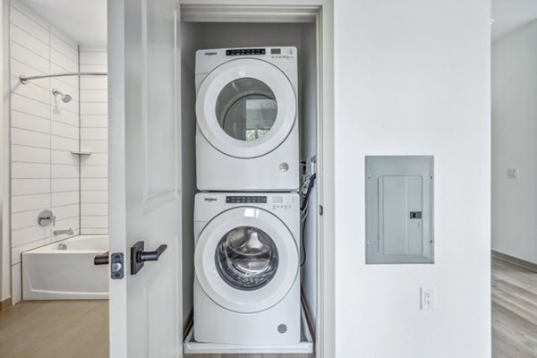 Laundry room with modern appliances at Enclave at Raritan Apartments