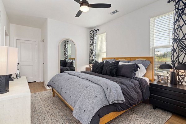 Bright, modern bedroom with elegant decor at The Lindley at Grove 98 Apartments