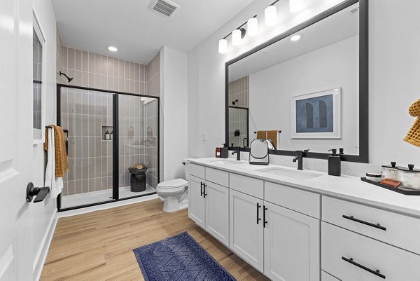 The Lindley at Grove 98 Apartments: Modern bathroom with sleek fixtures and ample lighting