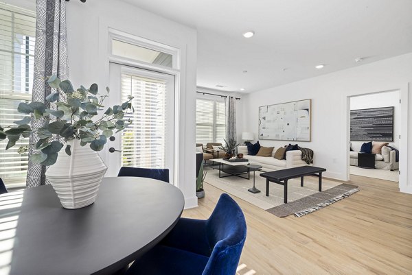 Dining area with modern furnishings and contemporary lighting at The Lindley at Grove 98 Apartments Perfect for luxurious social gatherings