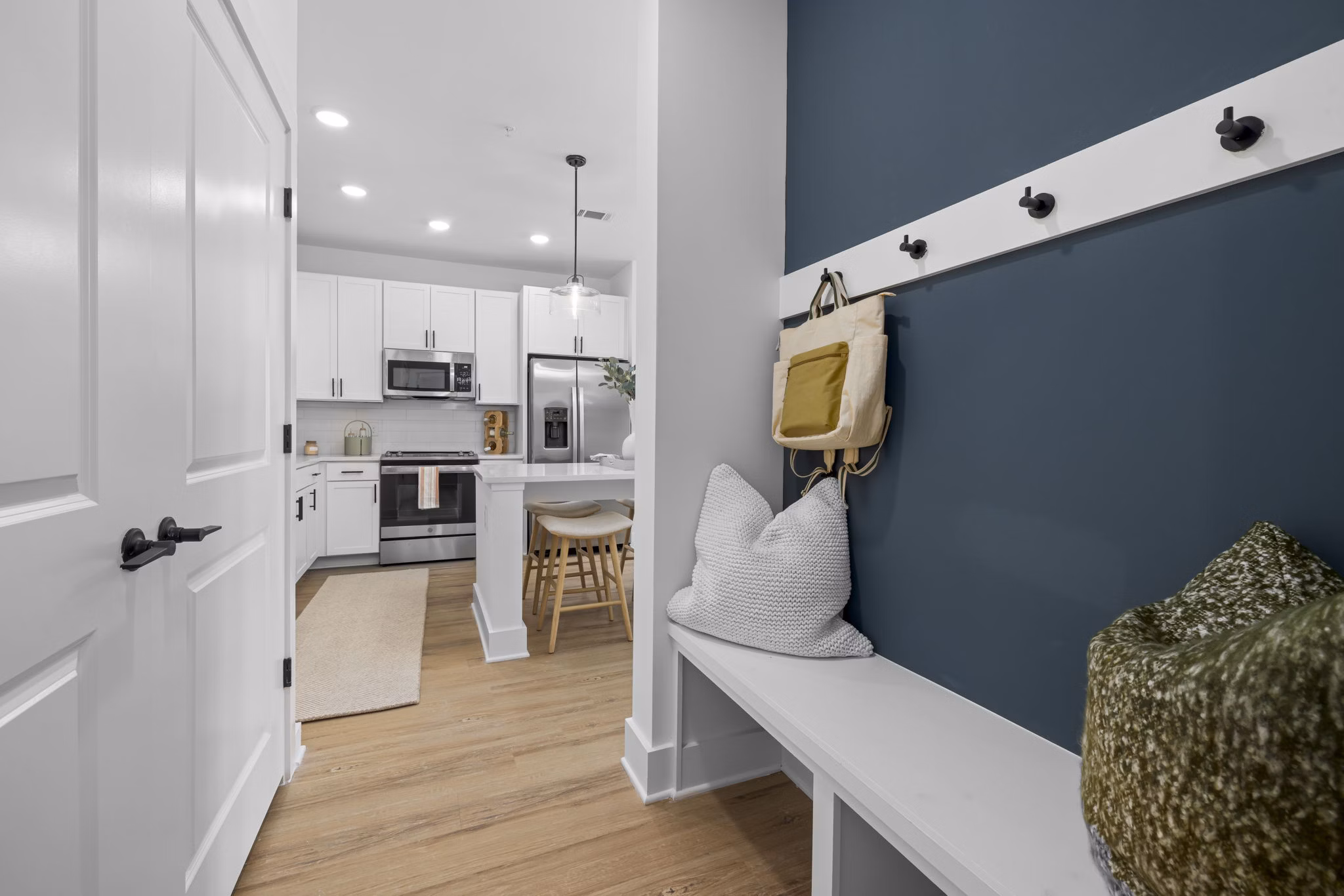 Elegant hallway with modern lighting fixtures at The Lindley at Grove 98 Apartments