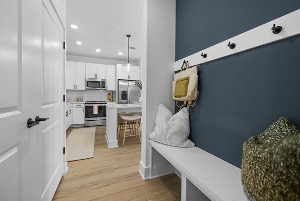 Elegant hallway with modern lighting fixtures at The Lindley at Grove 98 Apartments