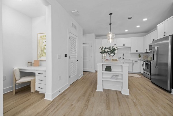 Spacious kitchen featuring modern appliances and quartz countertops in The Lindley at Grove 98 Apartments