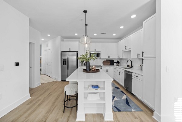 Modern kitchen with stainless steel appliances at Aventura Bellevue Apartments, luxury living by Greystar