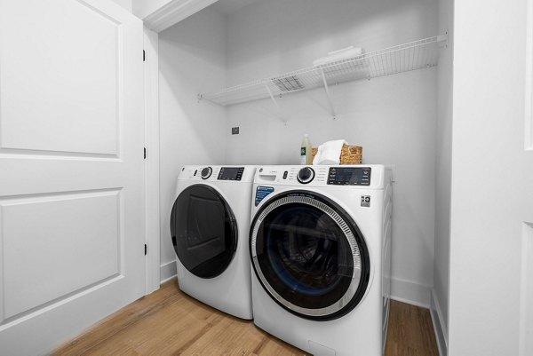 Laundry room with modern appliances at The Lindley at Grove 98 Apartments