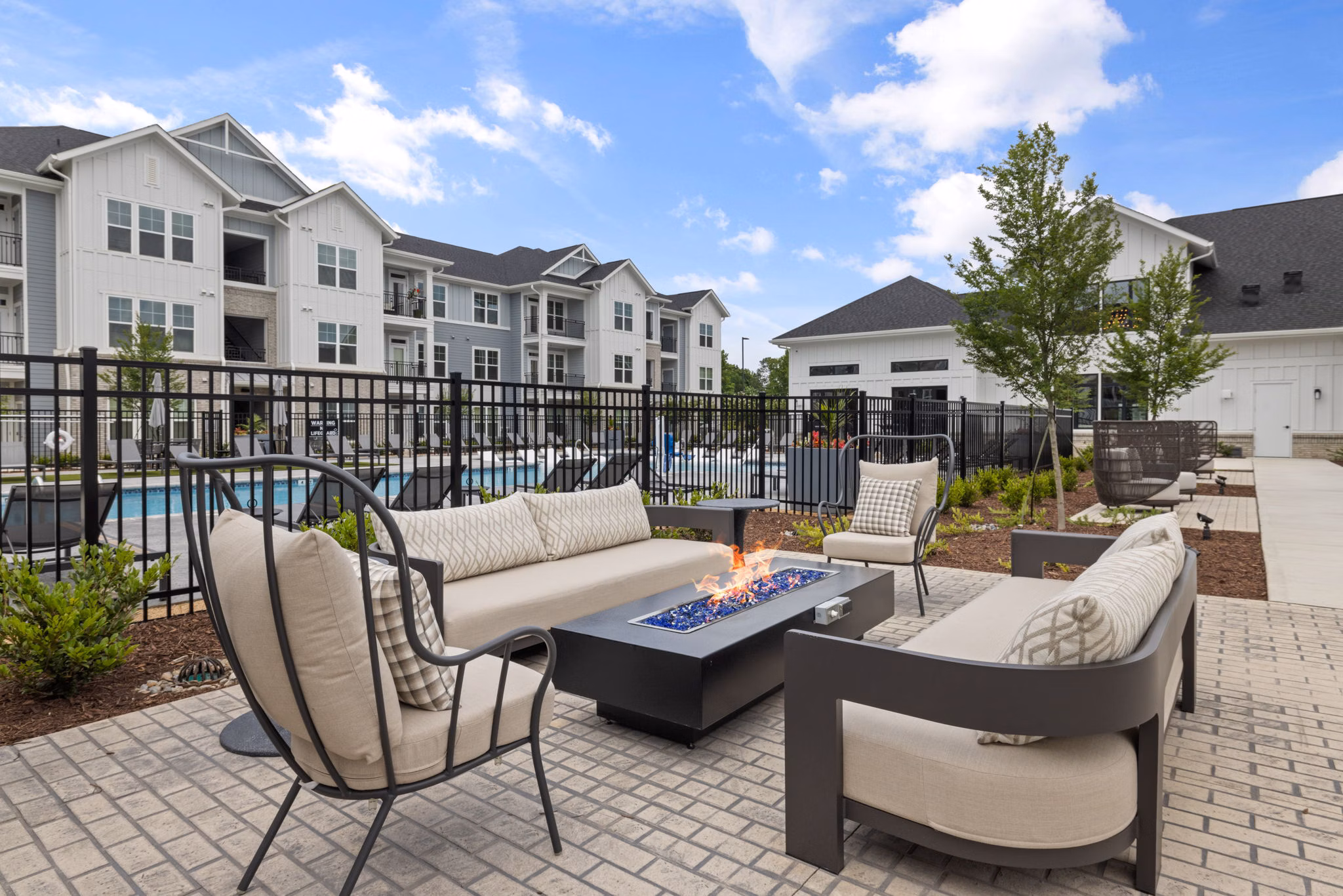 Fire pit lounge area at The Lindley at Grove 98 Apartments featuring cozy seating and ambient lighting