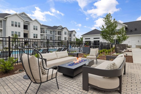 Fire pit lounge area at The Lindley at Grove 98 Apartments featuring cozy seating and ambient lighting