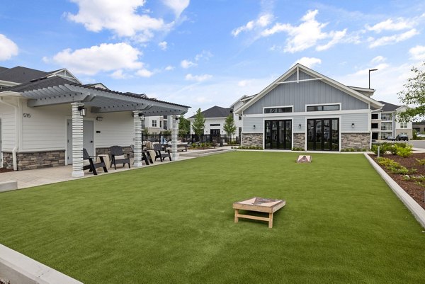 Courtyard featuring lush landscaping and seating at The Lindley at Grove 98 Apartments