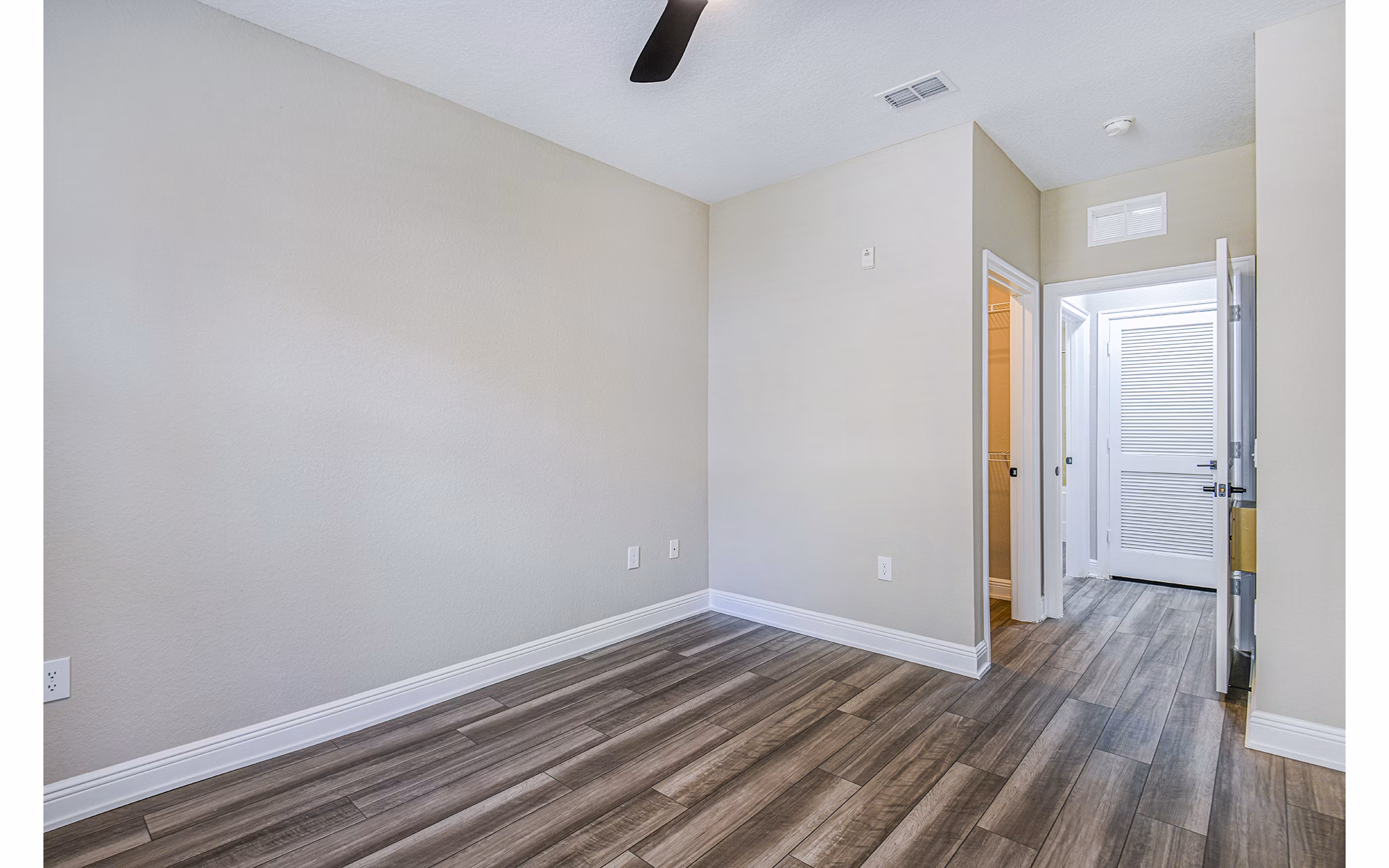 Spacious bedroom with modern decor at The Village at Lake Lily Apartments