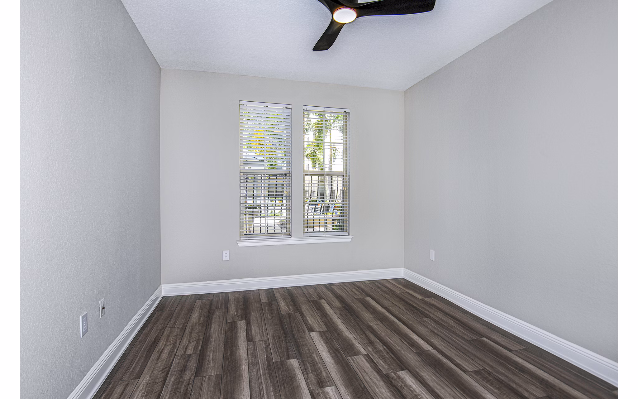 Cozy bedroom with elegant decor in The Village at Lake Lily Apartments