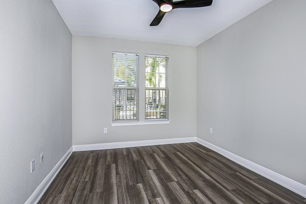 Cozy bedroom with elegant decor in The Village at Lake Lily Apartments