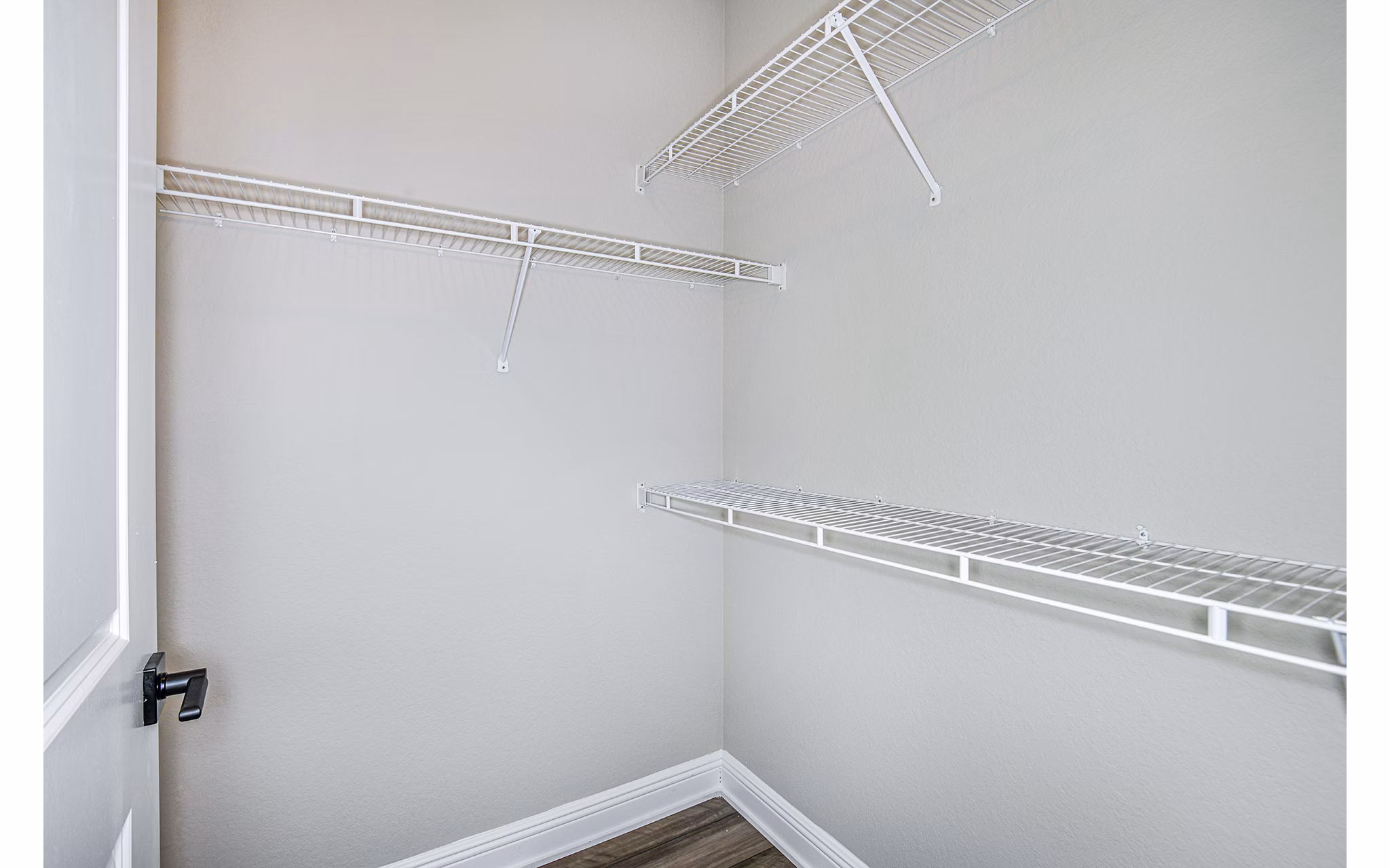 Bedroom with built-in closet at The Village at Lake Lily Apartments