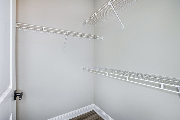 Bedroom with built-in closet at The Village at Lake Lily Apartments