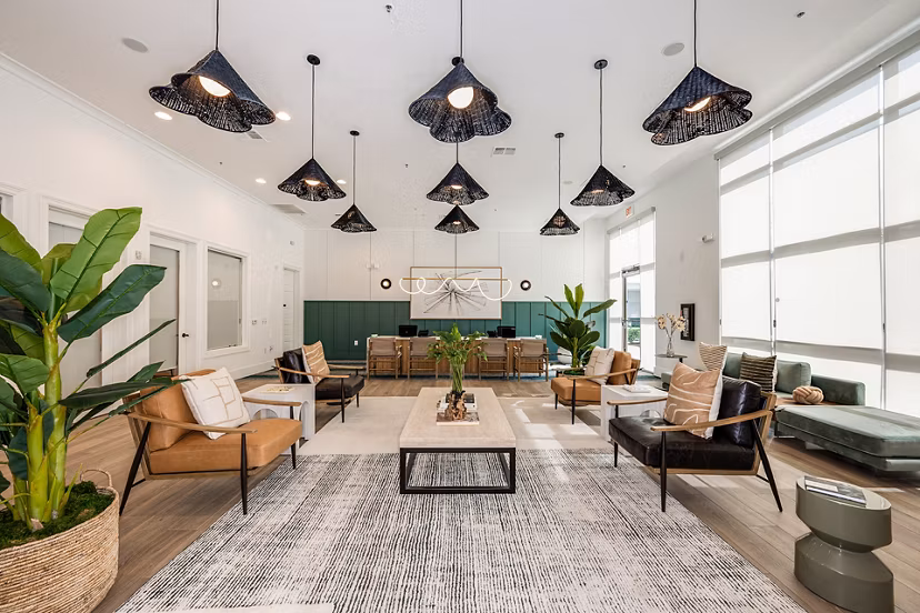 Clubhouse at The Village at Lake Lily Apartments featuring modern seating and decor
