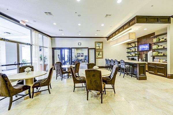 Clubhouse at The Village at Lake Lily Apartments featuring modern seating and decor