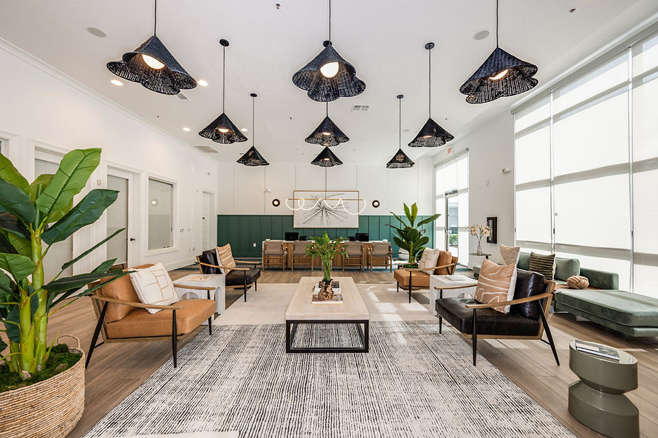 Clubhouse at The Village at Lake Lily Apartments featuring modern seating and decor