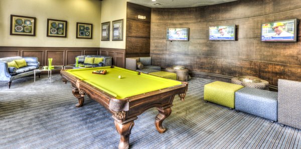 Modern clubhouse game room featuring billiards table at The Village at Lake Lily Apartments, a luxury community