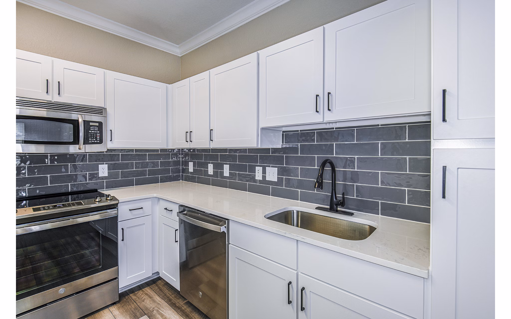 Modern kitchen with sleek countertops and stainless appliances at The Village at Lake Lily Apartments