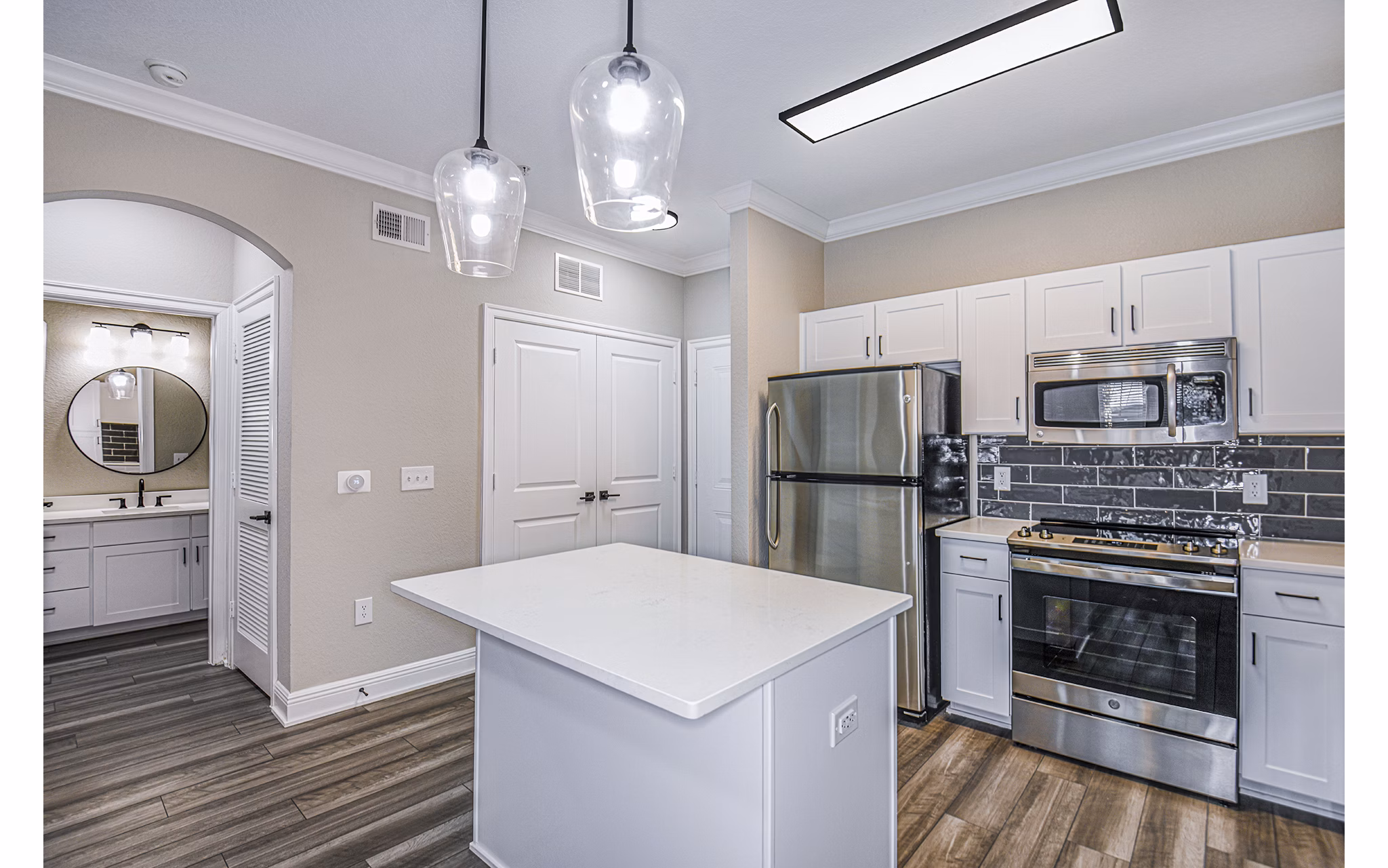 Modern kitchen with stainless steel appliances at The Village at Lake Lily Apartments