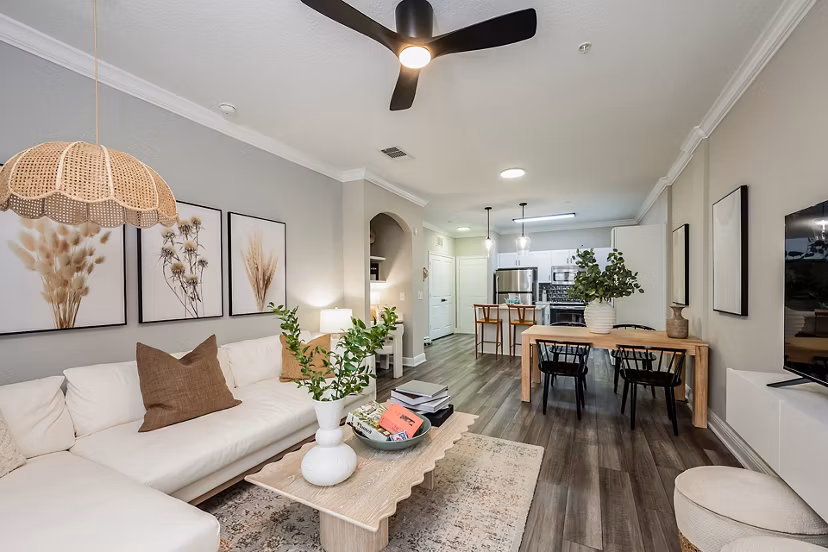 Contemporary living room featuring modern furnishings and large windows at The Village at Lake Lily Apartments
