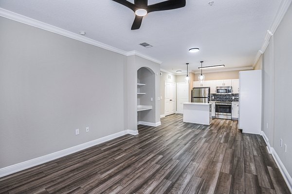 Contemporary living room featuring modern furnishings and large windows at The Village at Lake Lily Apartments