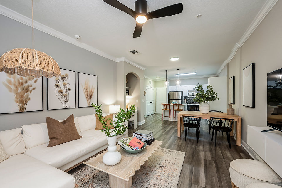 Contemporary living room featuring modern furnishings and large windows at The Village at Lake Lily Apartments