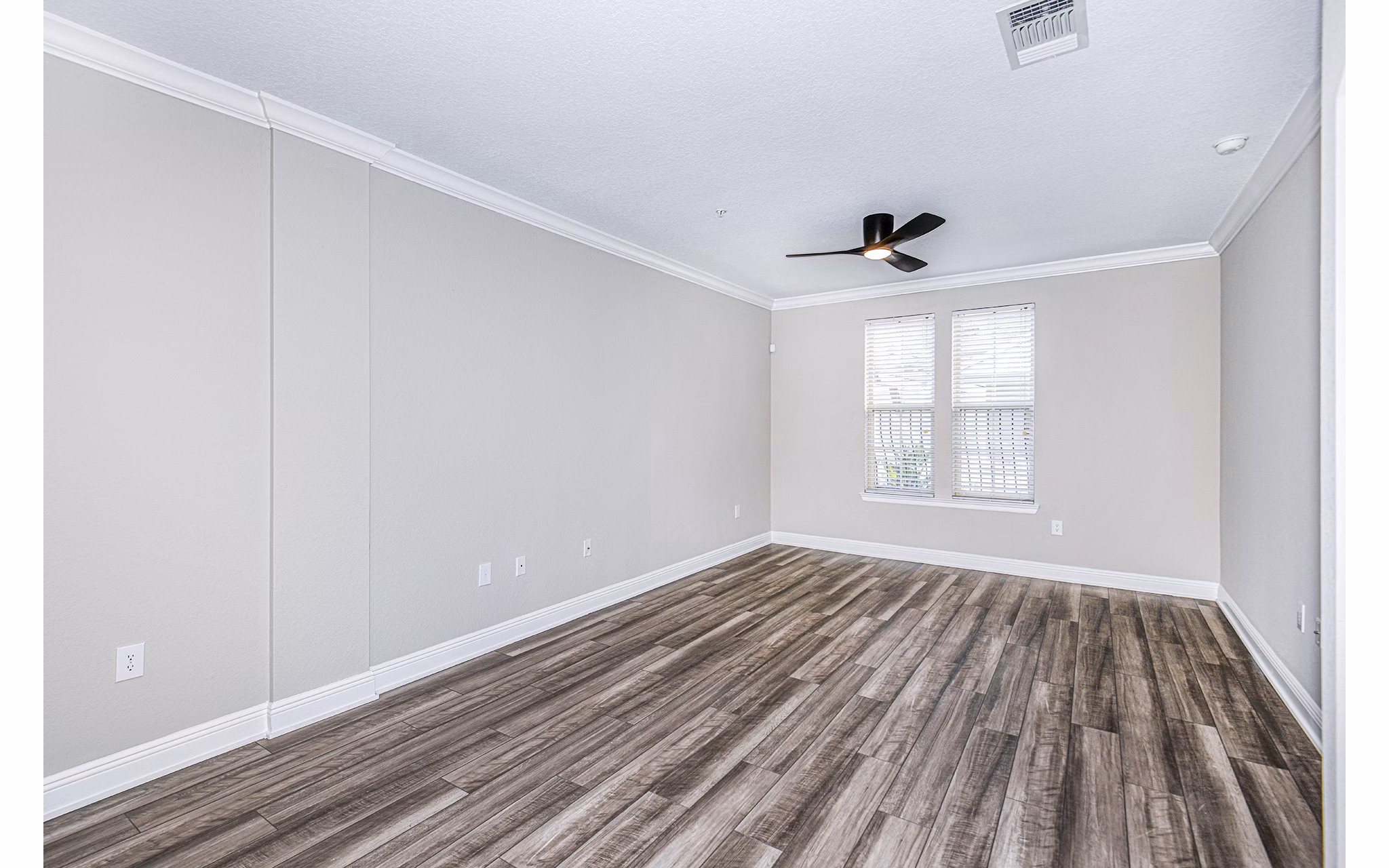 Spacious living room with modern decor at The Village at Lake Lily Apartments