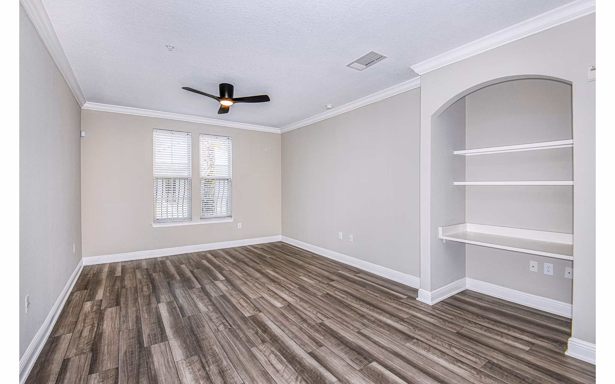 Living room and home office area featuring modern furniture at The Village at Lake Lily Apartments