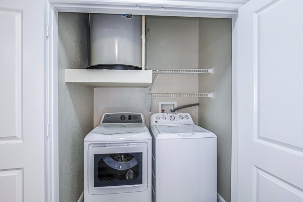Laundry room with modern appliances at The Village at Lake Lily Apartments