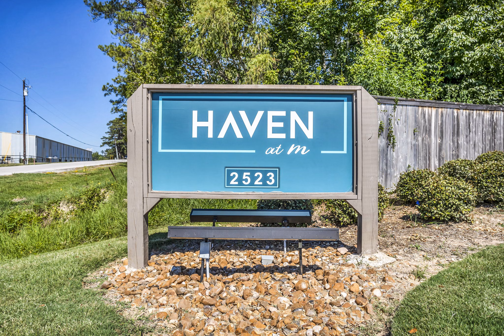 Signage for luxury apartments at Haven at M in an urban setting, with sleek design and modern branding