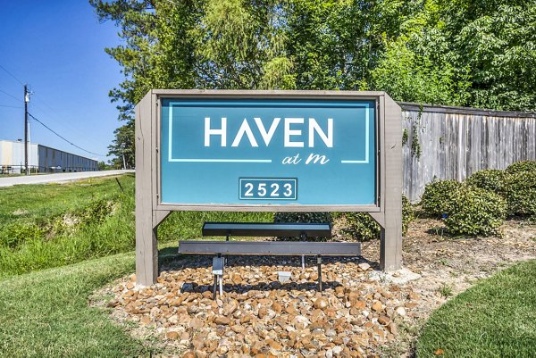 Signage for luxury apartments at Haven at M in an urban setting, with sleek design and modern branding