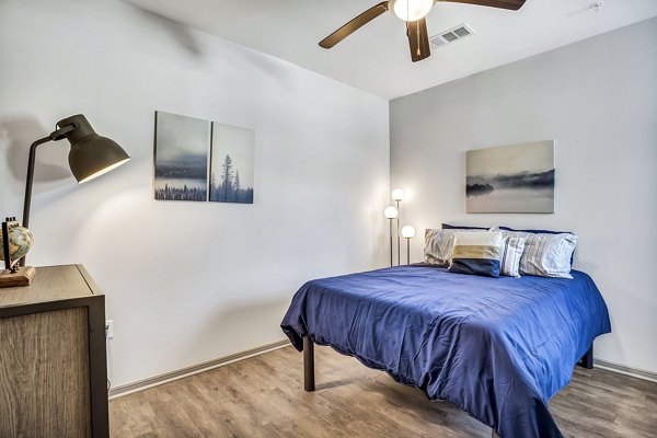 Bedroom with plush bedding and stylish decor at Haven at M Apartments