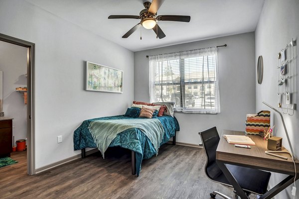 Luxurious bedroom featuring modern decor and ample natural light at Haven at M Apartments