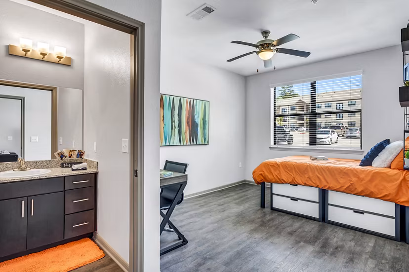 Haven at M Apartments: Cozy bedroom with modern decor and large windows providing ample natural light