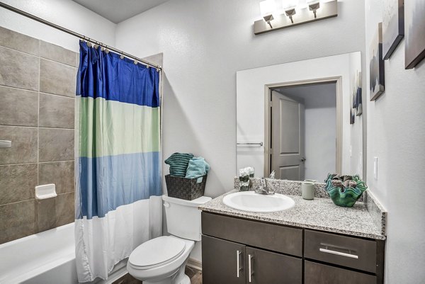 Modern bathroom featuring sleek fixtures and marble countertops in Haven at M Apartments