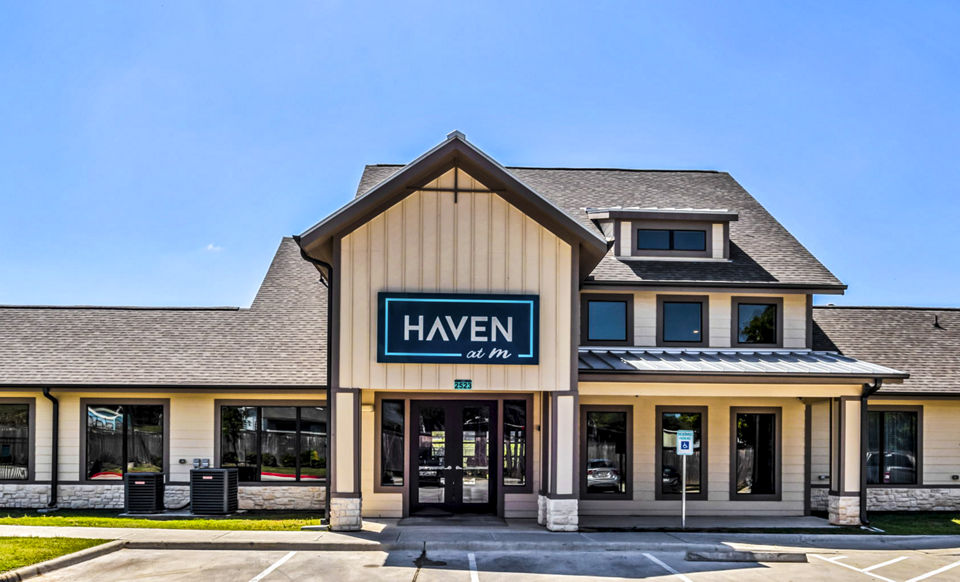 Stylish clubhouse with modern furnishings at Haven at M Apartments for resident gatherings