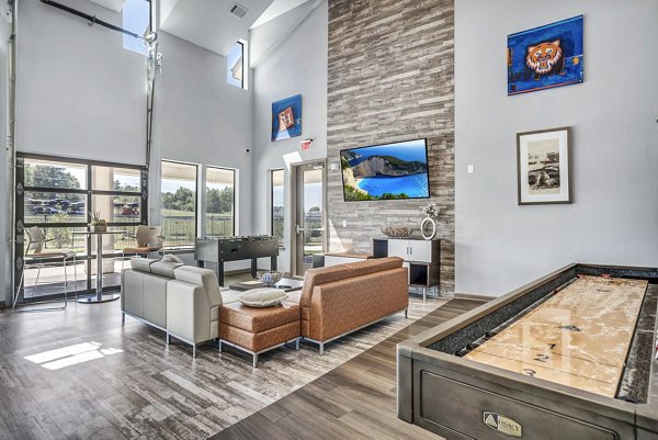 Clubhouse game room featuring pool table and modern seating at Haven at M Apartments Perfect for entertainment and relaxation