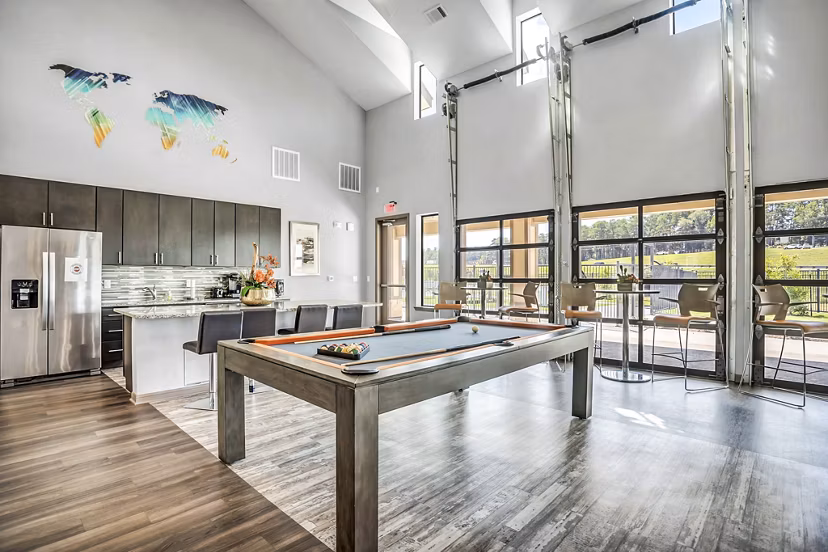 Clubhouse game room with pool table and lounge area at Haven at M Apartments for luxury living
