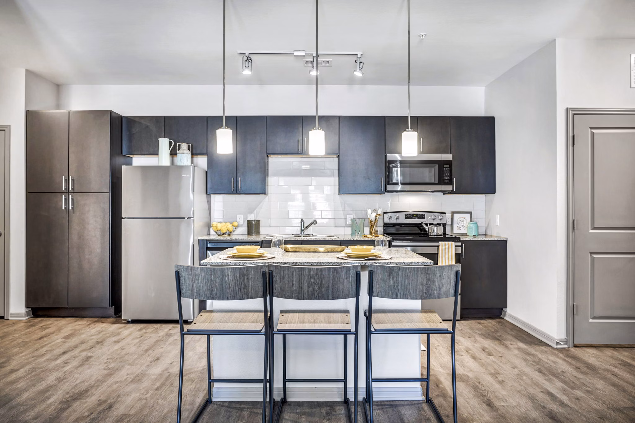 Dining room with modern kitchen appliances at Haven at M Apartments