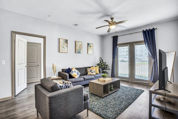 Bright living room with modern furnishings at Haven at M Apartments