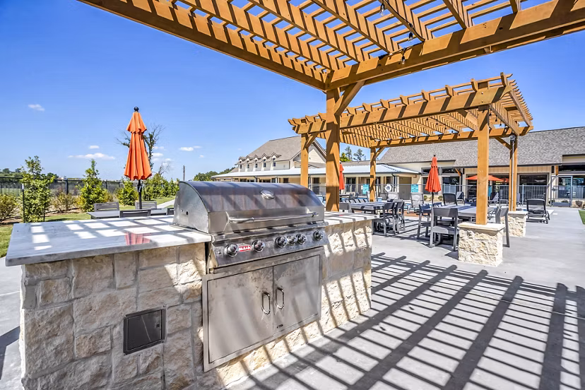 Grill area and patio with outdoor seating at Haven at M Apartments in a Greystar community