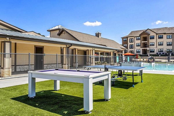 Modern recreational area at Haven at M Apartments featuring outdoor seating and vibrant landscaping