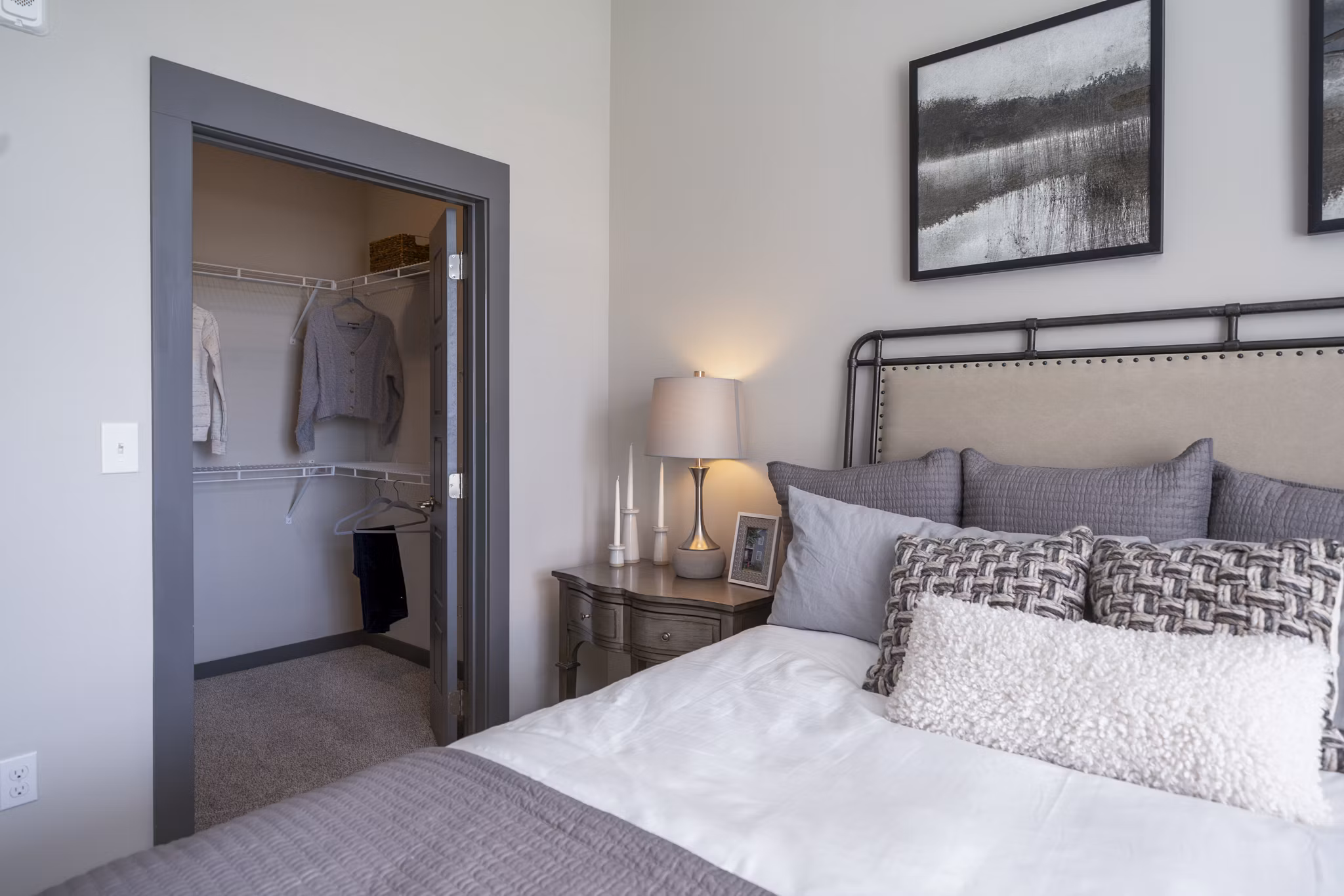 Cozy bedroom with modern decor at Sterling at Stonecrest Apartments: luxury living by Greystar